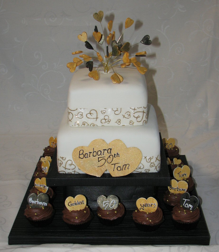 2 tire 50th anniversary cake with cupcakes and explosion of hearts