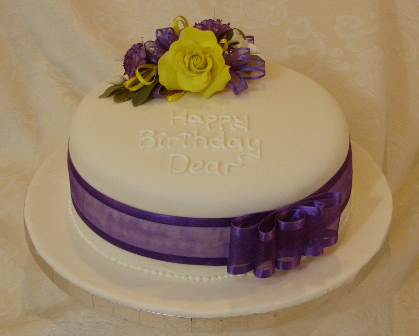 chocolate birthday cake with sugar rose and flowers