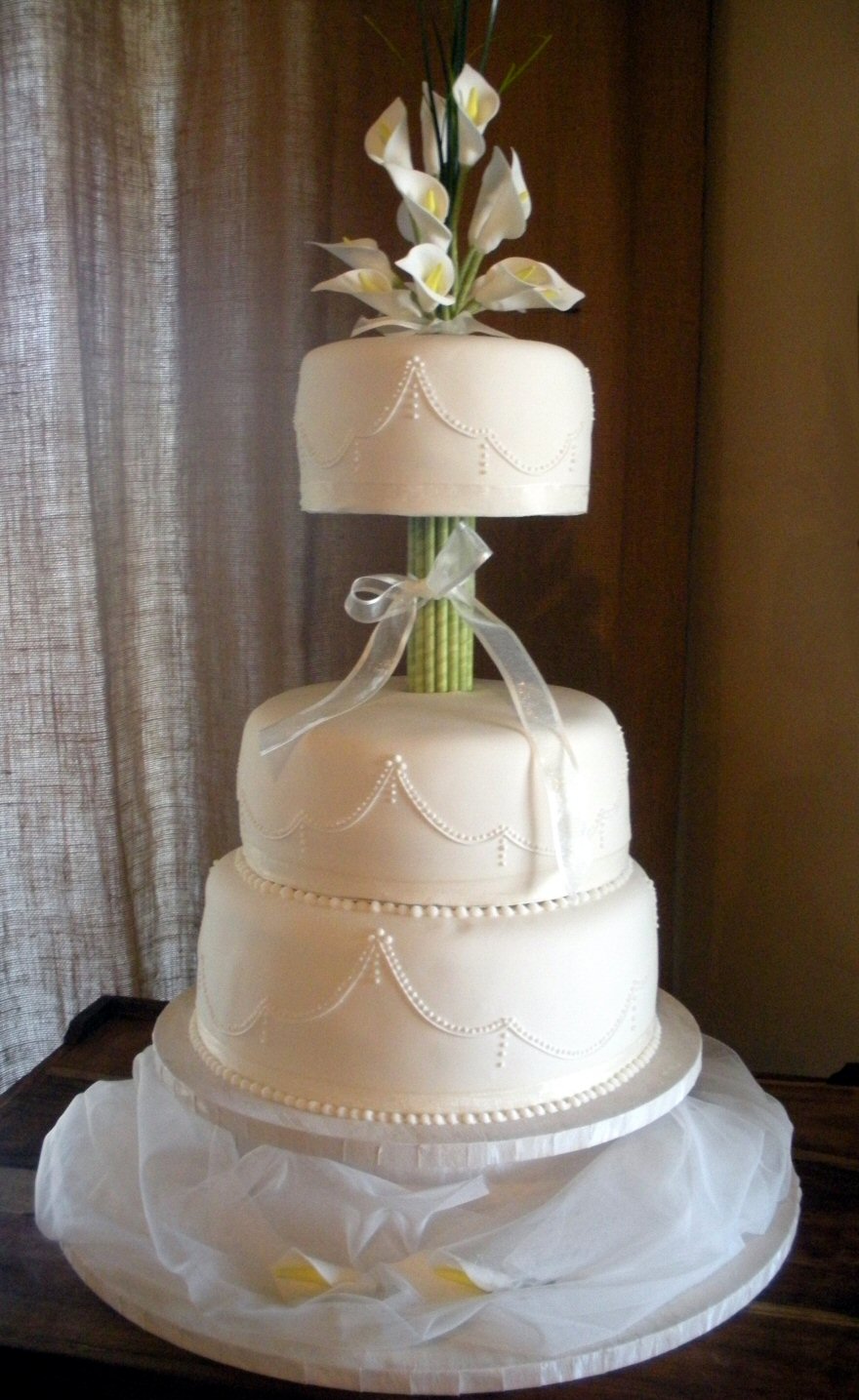 Bunch of sugar lilies on a 3 tier wedding cake