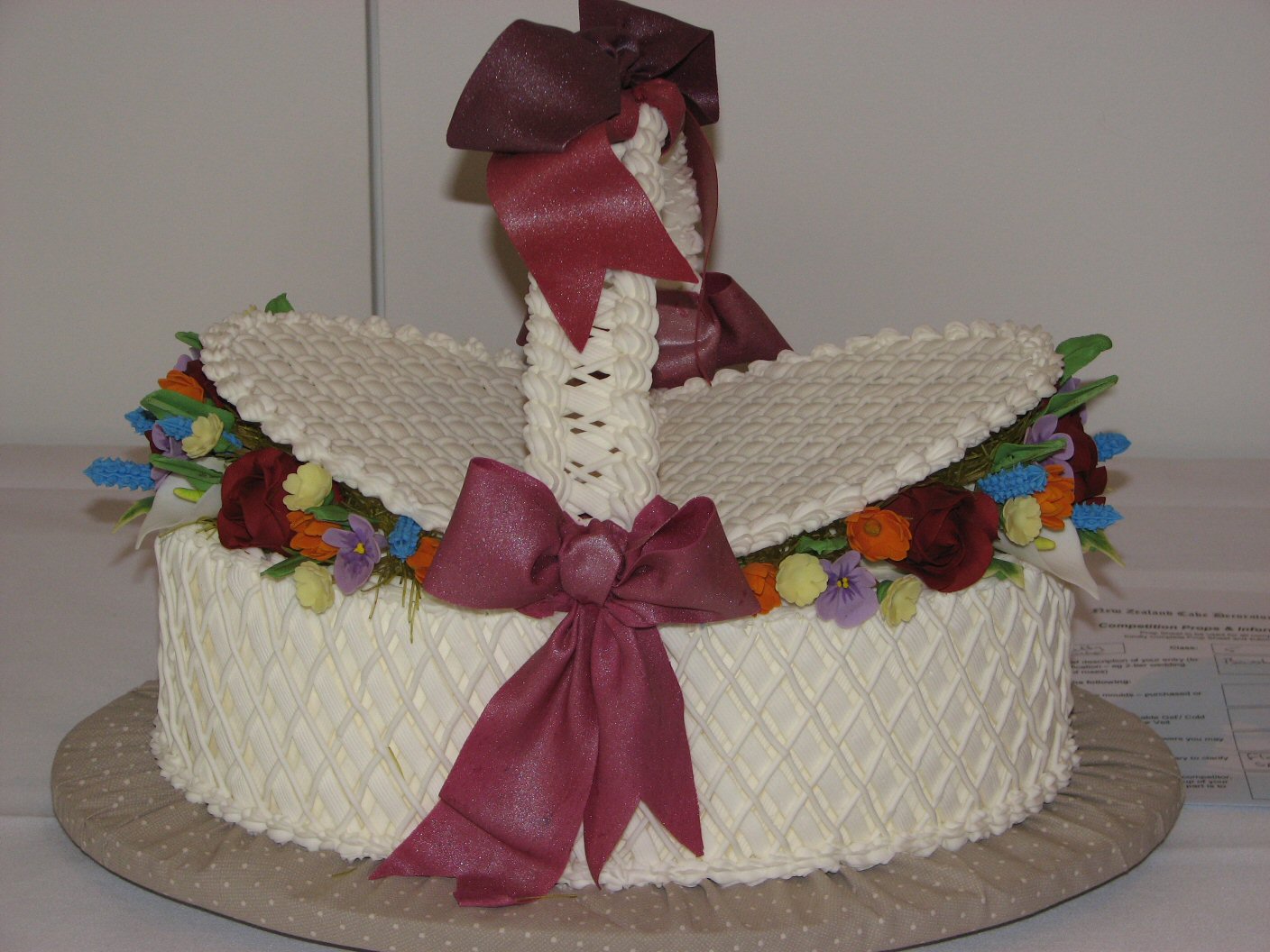 Royal iced oval basket of sugar flowers and bow
